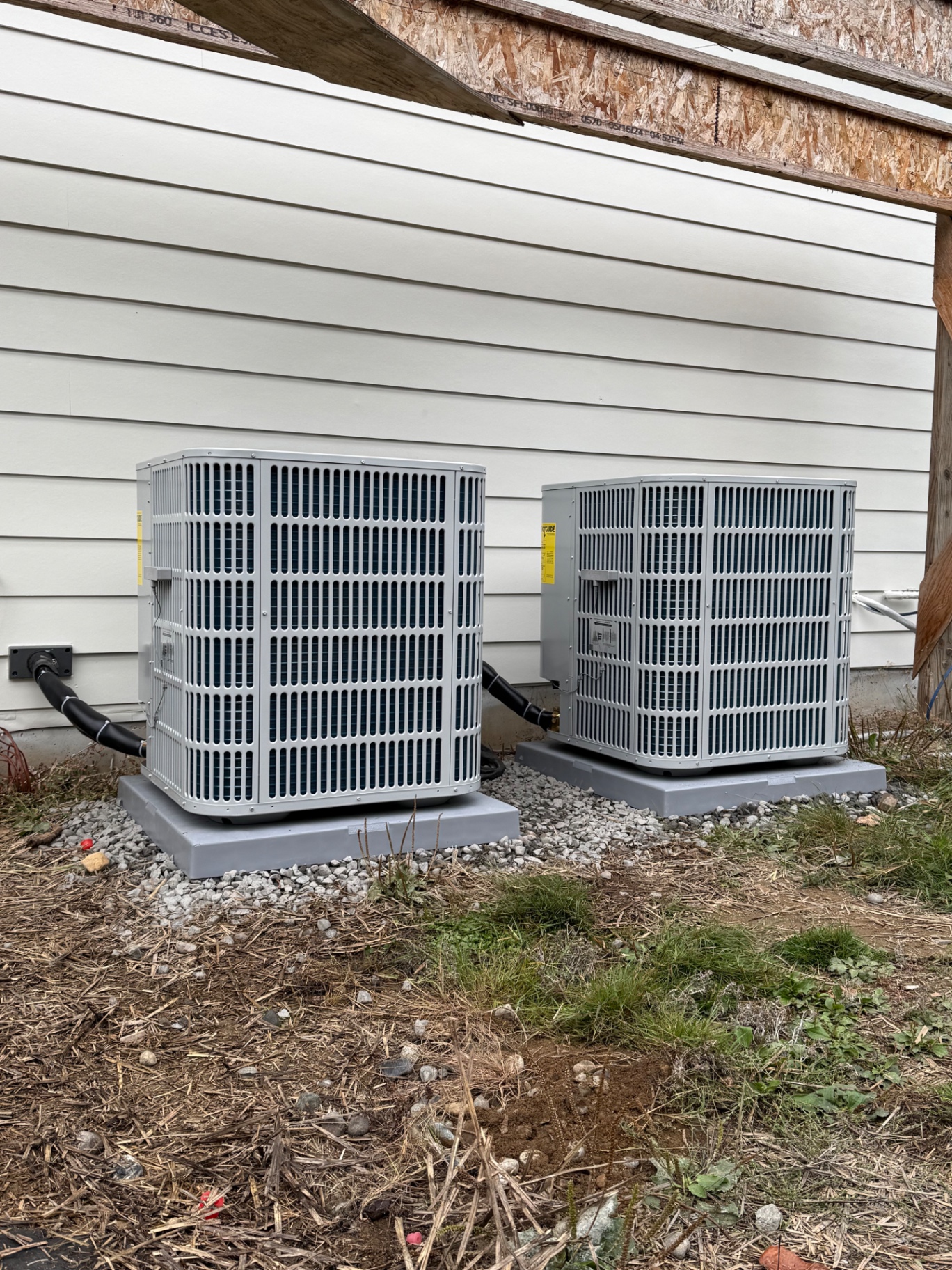 Two air conditioning condensers set on composite pads